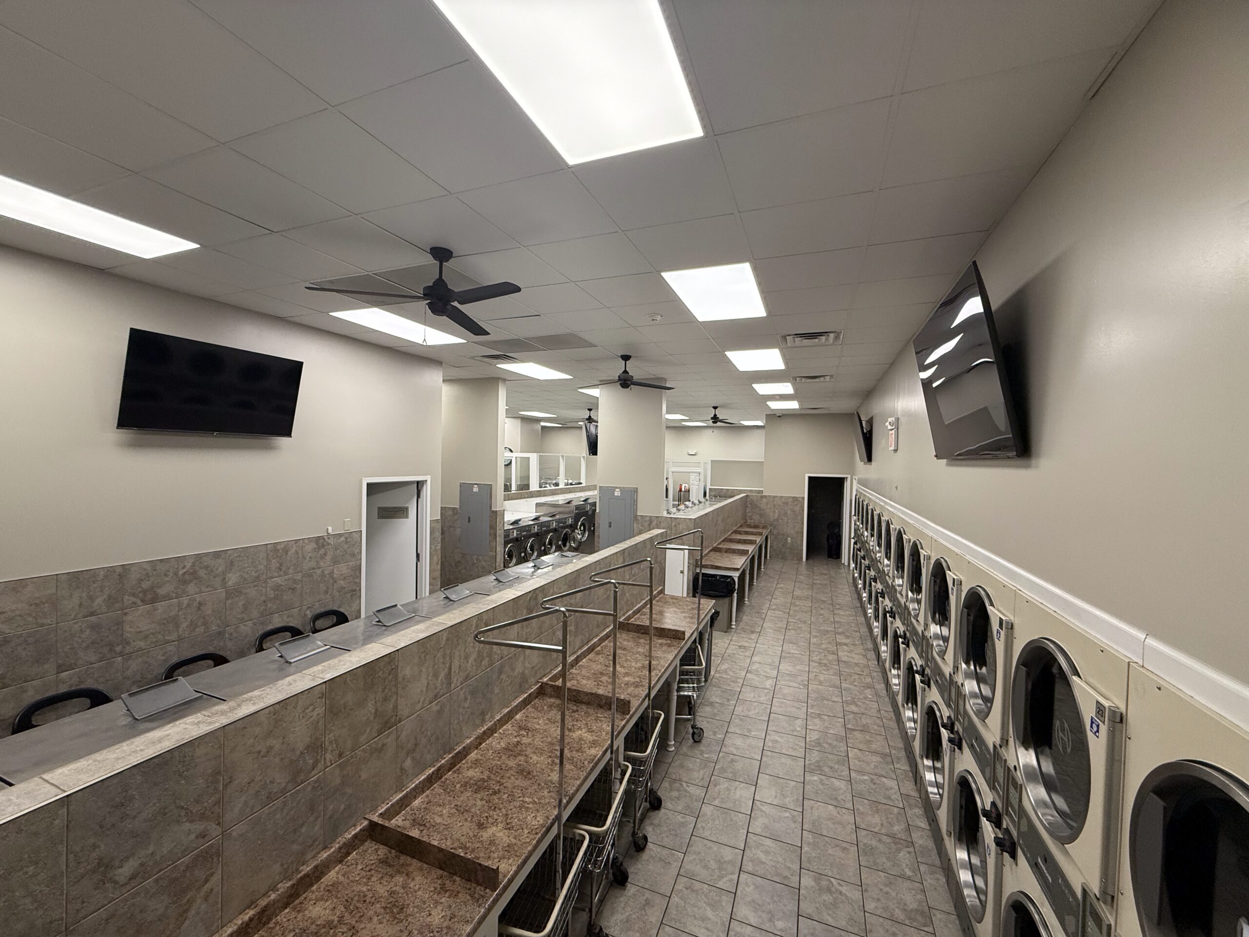 Wall of large dryers inside the Soap Gnome laundromat in Saddle Brook, NJ